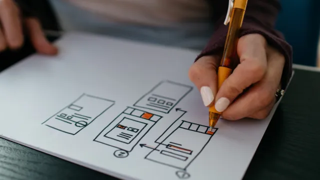 Photo of Mitchell drawing wireframes